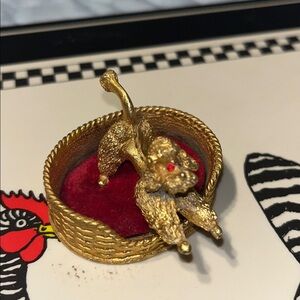 Vintage Forenza poodle in basket sitting on Red Velvet with red Ruby eyes.